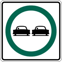 White square sign with a green circle around two black cars, one beside the other.