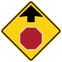 Yellow diamond warning sign with an upward arrow above a red stop-sign symbol.
