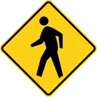 Yellow diamond warning sign showing a person walking.