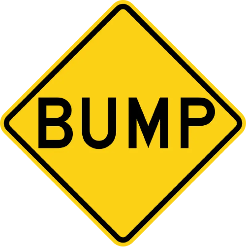 Yellow diamond warning sign with the word BUMP in black letters.