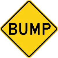 Yellow diamond warning sign with the word BUMP in black letters.