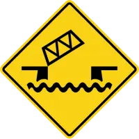 Yellow diamond sign showing a black drawbridge raised over wavy lines that represent water.
